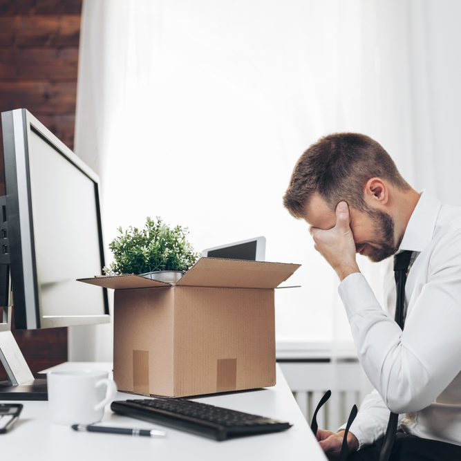 Dissapointed,Businessman,Clearing,His,Desk,After,Being,Made,Redundant