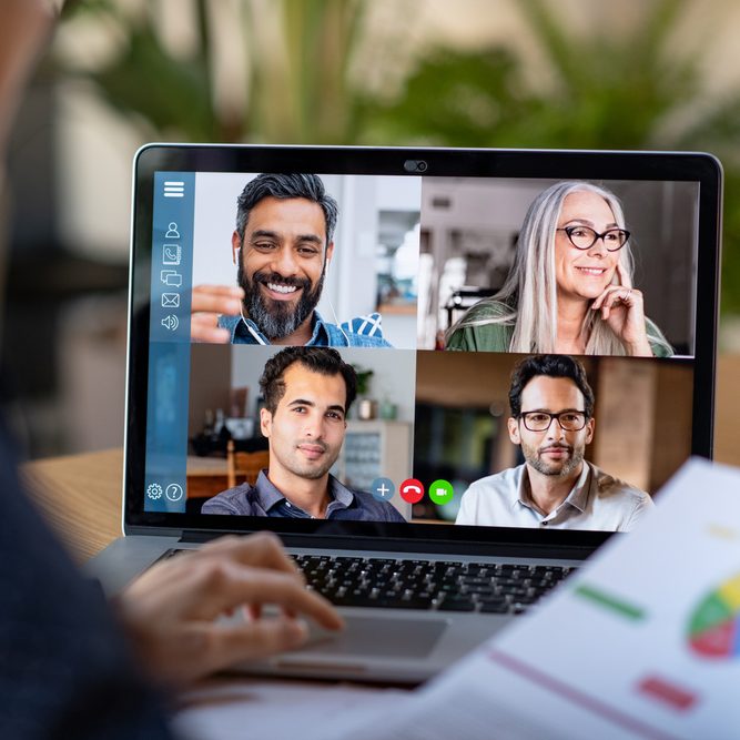 Back,View,Of,Business,Woman,Talking,To,Her,Colleagues,About